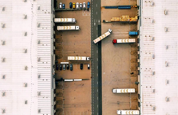 Aerial view of trucks parked at a warehouse loading dock