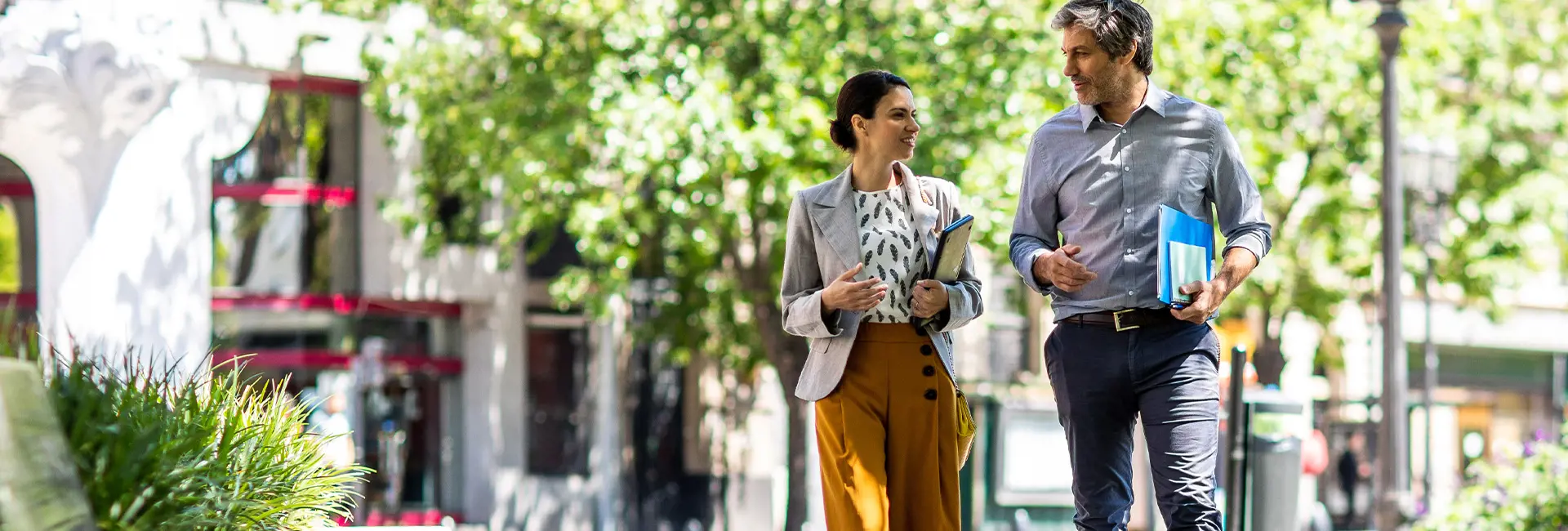 Two professionals walking outdoors, discussing CO2 reduction strategies.