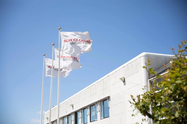 Flags with the Scan Global Logistics logo flying outside the former headquarters at Kirstinehøj, Amager